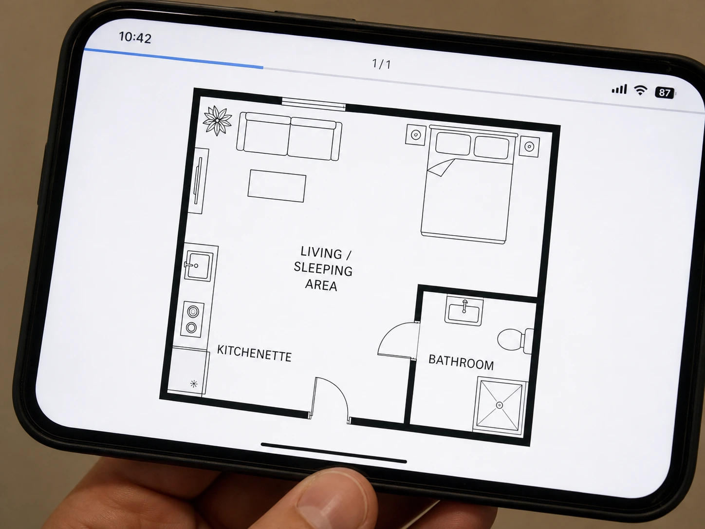 A pencil sketch of a studio apartment redrawn as a labelled floor plan